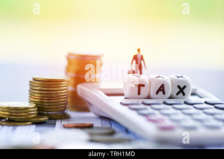 Tax concept and finances businessman and calculator stacked coins on invoice bill paper for time tax filling paid debt payment Stock Photo