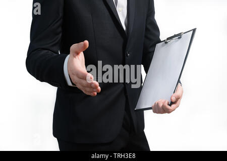young business man wearing a suit while holding sign board and giving handshake, clipping path, space for text Stock Photo