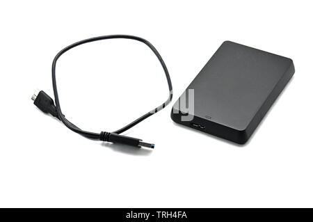 Portable hard drive for backing up various files on an isolated white background Stock Photo