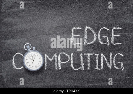 edge computing phrase written on chalkboard with vintage stopwatch used instead of O Stock Photo