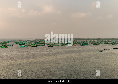 fishing boats are anchored in sea at rameswaram india. Image is taken form away providing wide look of boats, sea and sky. Stock Photo