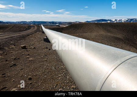Near Myvatn, north-east Iceland. Insulated pipes carry high pressure steam from volcanic boreholes to the Krafla geothermal power plant Stock Photo