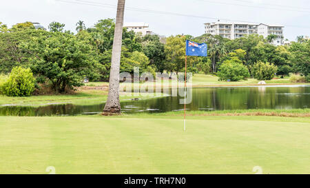 The Australian Flag flies over a golf course in a park in Darwin, Australia Stock Photo