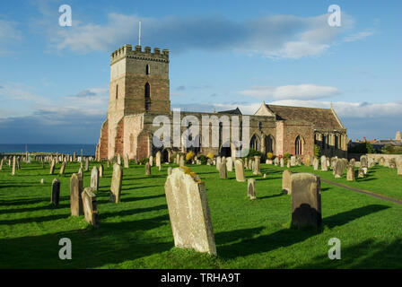 St Aidan's a grade I listed church in the seaside village of Bamburgh, Northumberland; the earliest parts of the building date from the 12th century Stock Photo