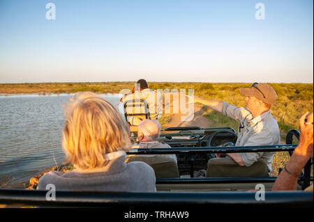 Tourists looking for wildlife while on safari at the Phinda Private Game Reserve, an andBeyond owned nature reserve in eastern South Africa. Stock Photo