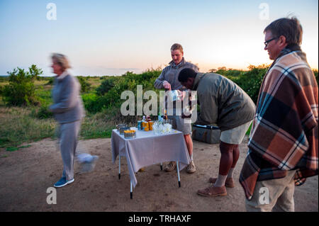 Tourists enjoying evening cocktails while on safari at the Phinda Private Game Reserve, an andBeyond owned nature reserve in eastern South Africa. Stock Photo
