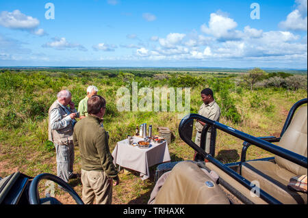 Tourists having a coffee break while on safari at the Phinda Private Game Reserve, an andBeyond owned nature reserve in eastern South Africa. Stock Photo