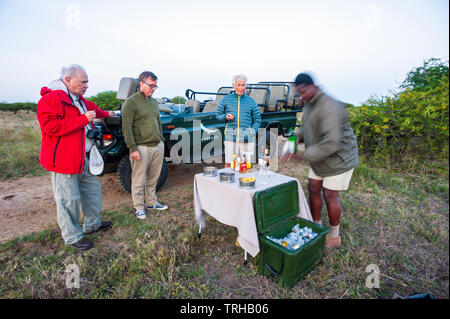 Tourists stop for cocktails while on safari at the Phinda Private Game Reserve, an andBeyond owned nature reserve in eastern South Africa. Stock Photo