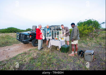 Tourists stop for cocktails while on safari at the Phinda Private Game Reserve, an andBeyond owned nature reserve in eastern South Africa. Stock Photo