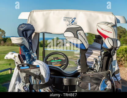 Two sets of golf clubs in the back of a golf cart at Gardiners Bay Country Club in Shelter Island, NY Stock Photo