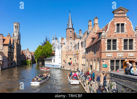 Iconic view Tourists in boats for boat trips leaving from the Rozenhoedkaai Rozenhoedkai Quay of the Rosary Den Dijver canal Bruges Belgium EU Europe Stock Photo