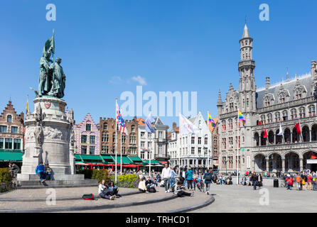 Old buildings with ornate gables behind the statue of Jan breydal and pieter de coninck in the historic market square Markt Bruges Belgium EU Europe Stock Photo