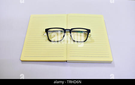 Picture of spectacles on top of a diary. Stock Photo
