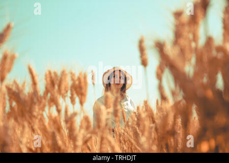 Young girl sitting on train rail track using her mobile phone and headphone Stock Photo