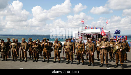 Portsmouth, UK. 6th June, 2019. World War II re-enactors walk the original route of the d-day soldiers took through Portsmouth to the landing craft, at South Parade Pier in Southsea, Portmsouth Thursday June 6, 2019. D-day commemorations marking the 75th anniversary of the d-day landings Photograph : Credit: Luke MacGregor/Alamy Live News Stock Photo