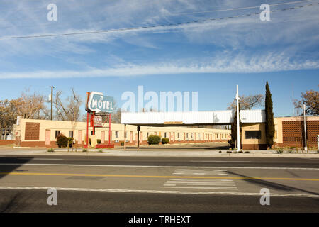 Albuquerque, New Mexico - February 1, 2019: Blue and red sign of the 21 Motel on historic Route 66. Showing sign, motel, and highway in morning sun. Stock Photo