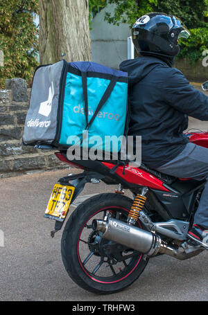 Deliveroo delivery driver for the online food ordering and delivery service. Seen in Bournemouth, UK. Stock Photo