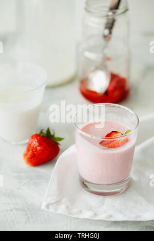 Homemade organic fresh raspberry smoothie with fermented kefir(yogurt,ayran,lassi,milky product) for dieting breakfast in glass on white background Stock Photo