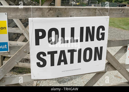 Close up of polling station sign signage on a gate England UK United Kingdom GB Great Britain Stock Photo