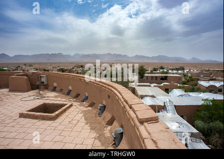 View over Aqda from the town gate. Aqda is a mud brick town in the desert outside of Yazd, Iran. It's currently being restored for the tourism market. Stock Photo