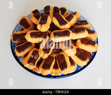 A view of a dish of mini eclairs for sharing for a dessert course. Stock Photo