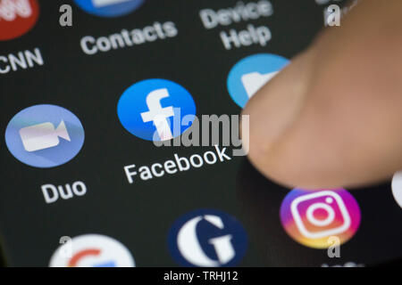 Facebook logo icon on mobile phone screen Stock Photo