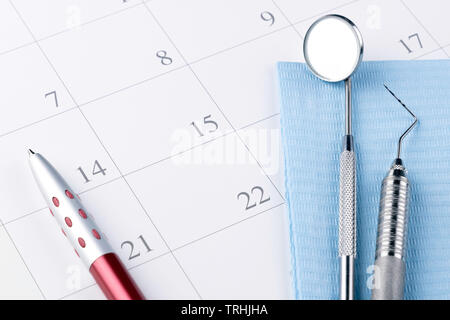 Dentist appointment in calendar pen and professional dental tools.- Image Stock Photo