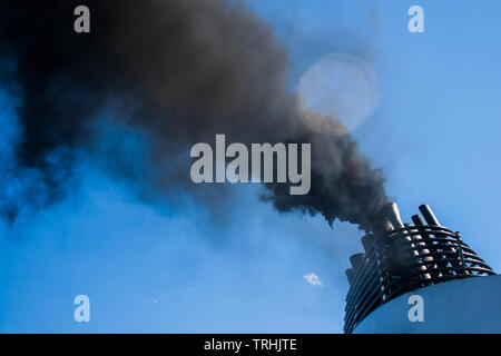 Ships funnel emitting black smoke, air pollution Stock Photo