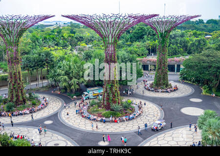 Tourists walking between artificial trees in the Supertree Grove vertical garden at Gardens by the Bay Singapore. Stock Photo