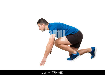 Side vie full length of determined caucasian man runner standing in running position looking ahead confident. Young guy sprinter wearing black and blu Stock Photo