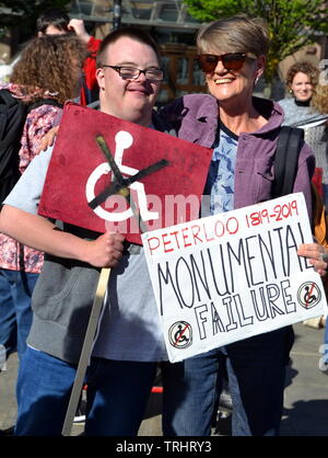 June 6, 2019. Disabled people and supporters protest at the site where a memorial to commemorate the Peterloo massacre of 1819 is being built in Manchester uk. The memorial, developed by Manchester City Council, will currently be a landscaped hill made out of concentric steps. The protesters argue that it is inaccessible for many disabled people and should be amended. On August 16, 1819, cavalry charged a crowd of some 60,000 people gathered on St Peter's Fields, Manchester, to demand the reform of parliamentary representation. Eighteen people were killed and hundreds injured. Stock Photo