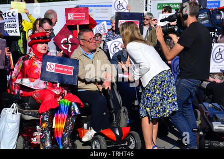 June 6, 2019. Elaine Willcox of 'Granada Reports' interviews disabled people protesting at the site where a memorial to commemorate the Peterloo massacre of 1819 is being built in Manchester uk. The memorial will currently be a landscaped hill made out of concentric steps. The protesters argue that it is inaccessible for many disabled people and should be amended. On August 16, 1819, cavalry charged a crowd of some 60,000 people gathered on St Peter's Fields, Manchester, to demand the reform of parliamentary representation. Eighteen people were killed and hundreds injure Stock Photo