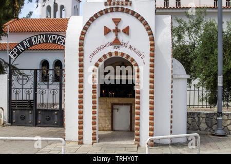 A small chapel outside a church in Chanioti,Halkidiki, Greece with candles burning inside. Stock Photo