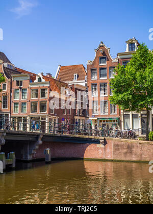 Canal houses in typical Dutch style in Amsterdam, the capital of The Netherlands. Stock Photo