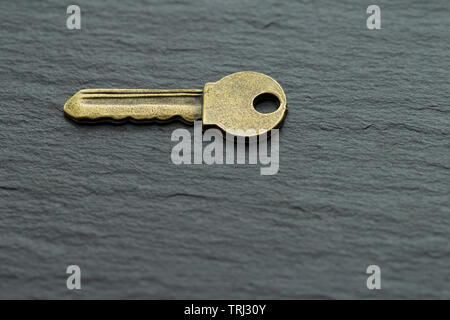 key on a dark slate background Stock Photo