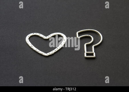 question mark and heart on a black background .likes or dislikes concept Stock Photo
