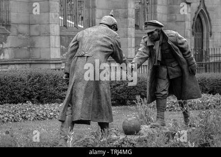 Christmas Truce statue 'All Together Now' by Andrew Edwards, commemorating the WWI Christmas truce and football match, at St Luke's Church, Liverpool