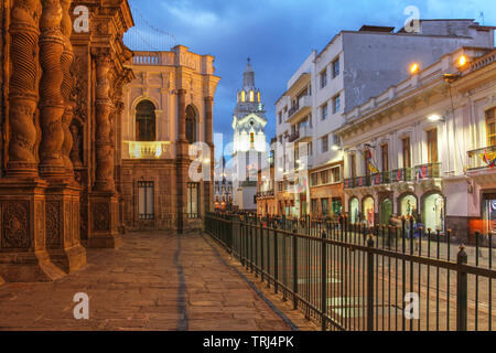 Night scene along Garcia Moreno street in Quito, Ecuador featuring Quito Cathedral and part of the Church of Jesuits.