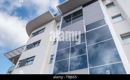 Modern new apartment with concrete exterior walls and large windows in Italy. Bottom view. Stock Photo