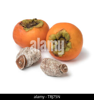 Dried kaki fruit and fresh orange ones isolated on white background Stock Photo