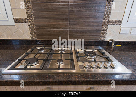 Interior design decor showing modern kitchen cooker hob appliance in luxury apartment showroom Stock Photo