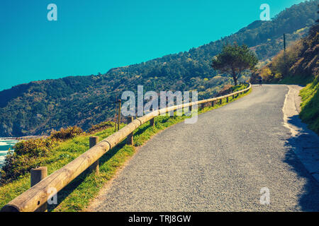 Mountain road along the sea on a sunny day Stock Photo