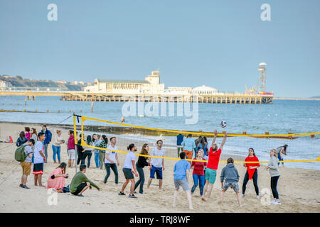 Volleyball on Bournemouth beach with the Pier to the rear. Dorset. England, UK. Stock Photo