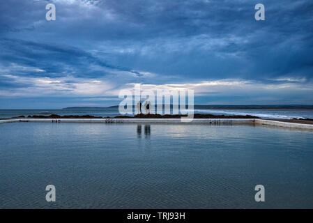 Dusk at the Rock Pool on the seafront at Westward Ho! in Devon England UK Stock Photo