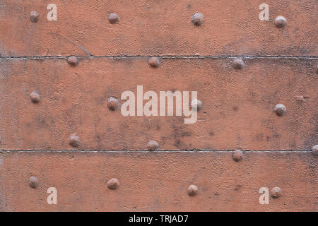 Old wooden, brown painted, door with nails texture background Stock Photo