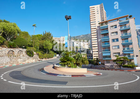 Monte Carlo street curve with formula one red and white signs in a sunny summer day in Monte Carlo, Monaco Stock Photo