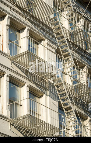 Traditional downtown New York City architecture featuring industrial facades lined with metal fire escapes in the SoHo-Cast Iron Historic District Stock Photo