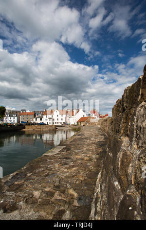 Village of Pittenweem, Scotland. The southern breakwater of Pittenweem Harbour, with harbour houses at Gyles in the background. Stock Photo