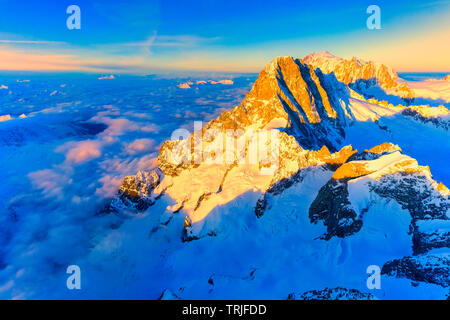 Aerial view of sea of clouds around Grandes Jorasses, Petites Jorasses and Mont Blanc, Courmayeur, Aosta Valley, Italy