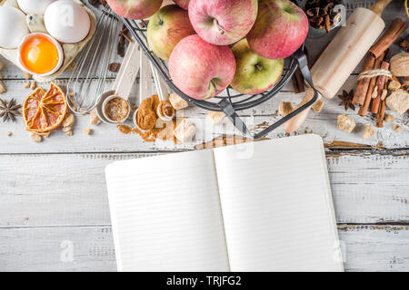 Autumn baking sale concept. Cooking seasonal fall baking background with ingredients, spices, apples, supplies, white wooden table top view copy space Stock Photo